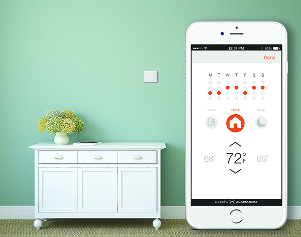 Alarm.com Smart Thermostat on wall